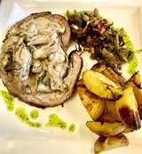 Stuffed veal roast with beef and brocciu, mushroom sauce, and baked potatoes - Restaurant I Fratelli in Rapale.