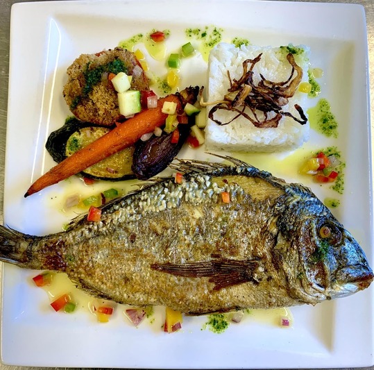 Oven-baked sea bream with olive oil, herbs, and virgin sauce - Restaurant I Fratelli in Rapale.